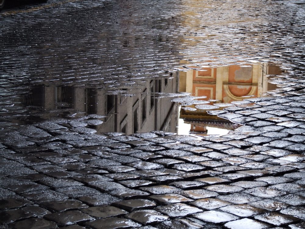 Cobblestone - old street in Rome (Italy). A view just after rain.